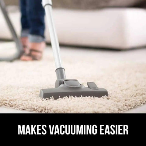 Vacuum cleaning a rug over Extra Strong Rug Pad Gripper 2x4 Ft For Hardwood Floors And Carpets, Slip Resistant Pad shown in living room