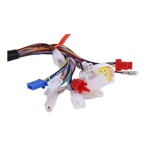 Close-up of motorcycle controller wiring harness with white connectors and multicolor wires