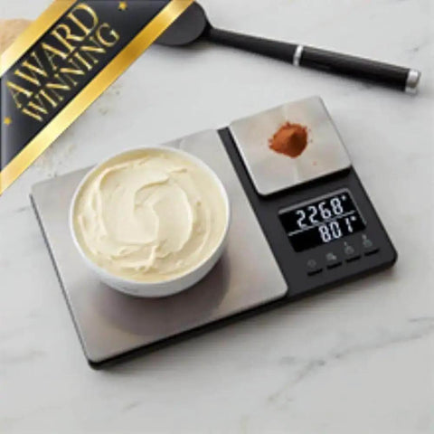 Award-winning dual-platform digital kitchen scale with food items, featuring stainless steel surface and backlit LCD readout.