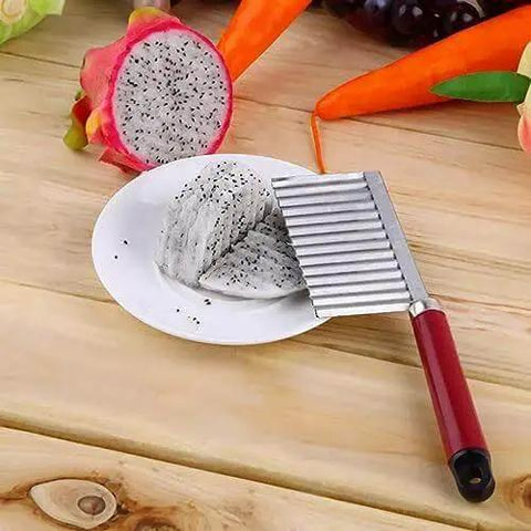 Crinkle Cut Potato Cutter Knife Stainless Steel Wave Slicer with red handle slicing dragon fruit on a plate