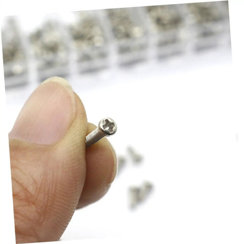 Close-up of a tiny screw held between fingers, part of a Miniature Screw Kit Set For Glasses Laptops Watches And Electronics With Durable Portable Storage Case For Easy Organization By Size And Style Quick Access To Tiny Screws For Everyday Carry Grab And Go.
