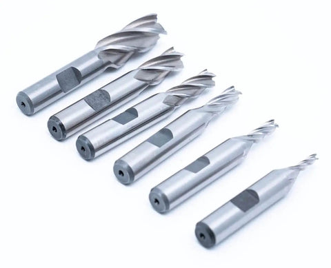 Center Cutting End Mill Set 6pc High Speed Steel 4 Flute Single End With 3/8 Inch Shank and Plastic Stand Includes 1/8, 3/16, 1/4, 5/16, 3/8, 1/2 Inch Mills for Precision Milling in Metal Wood and Plastic - front view of steel mills on white background