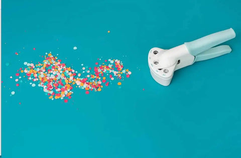 Multi Size Hole Punch For Leather, Paper, Fabric And More Rotates Through Five Hole Sizes with colorful confetti on teal background
