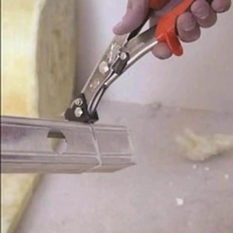 Close-up of NR1 Hand Nibbler with Built-In Waste Cutter cutting metal sheet, showing soft grip handles and precise nibbling action.