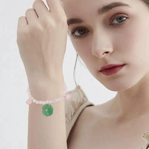 Woman wearing bracelet made with Dope Lotus Acrylic Beads Set, 24 Pieces in 7 Styles, 10-30mm mini flower and leaf beads, for jewelry making.