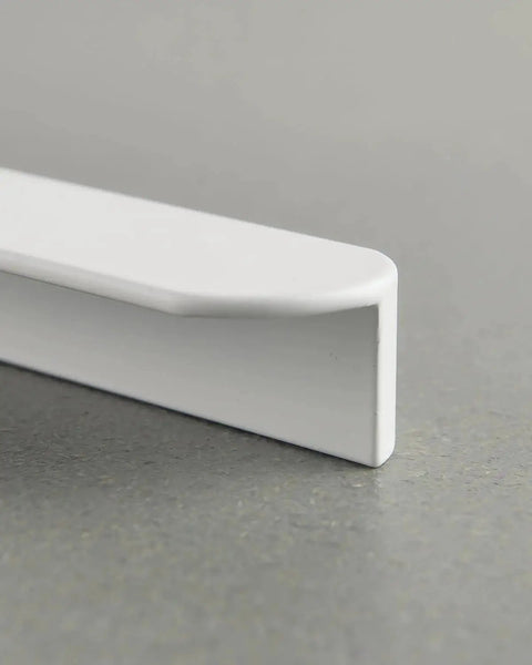 Close-up of a matte white kitchen cabinet handle showcasing its modern design, part of the Matte White Kitchen Cabinet Handles Pack Of 5 Cup Pulls 3.8 Inch Center To Center 4.7 Inch Long 0.98 Inch Wide Modern Cupboard Drawer Pulls For Kitchen Furniture Doors Wardrobe Vanities.