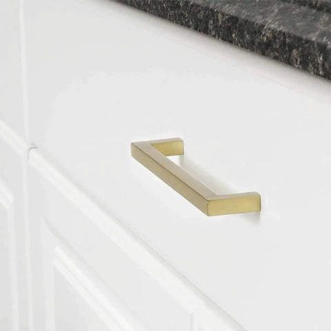 Modern Square Cabinet Pull Handle With Golden Champagne Finish, 5.39-Inch Length, installed on a white cabinet drawer.