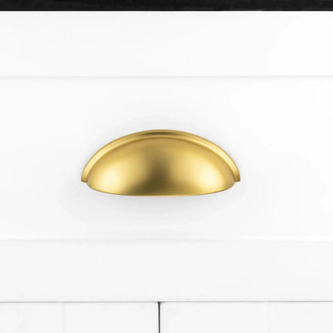 Brushed Gold Cup Drawer Pulls 3 Inch 76mm Set of 10 Durable Metal Cabinet Handles mounted on white drawer front.