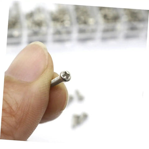 Close-up of a tiny screw from the Miniature Electronics Screw Kit For Repairs With Assorted Tiny Screws For Glasses, Watches, Laptops.