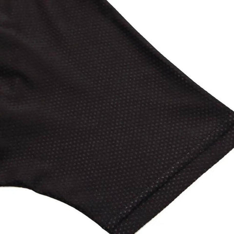 Close-up of a black textured fabric, focus on stitching and material detail.