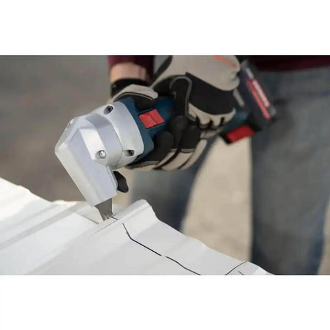 18V 16 Gauge Nibbler with Brushless Motor cutting sheet metal, showing rotating die holder, cordless use visible