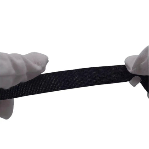 Close-up of heavy duty cloth electrical tape for automotive and home use, showing texture and elasticity, held between gloved hands.