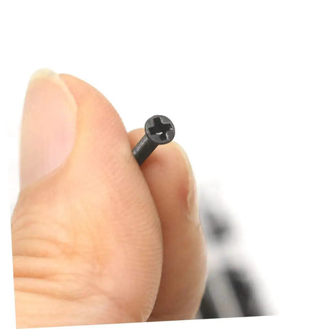 Close-up of a countersunk round head screw from the Miniature Screw Kit For Glasses, Watches And Electronics in hand