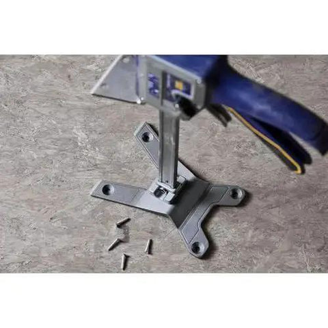 Top view of Quick Lift Construction Jack With 10 Inch Lift And 330 Lb Capacity on a floor with scattered screws
