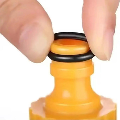 Close-up of black O-ring from 225 Piece Flat Washer And O Ring Heavy Duty Rubber Assortment Kit on yellow fitting for plumbing and sealing