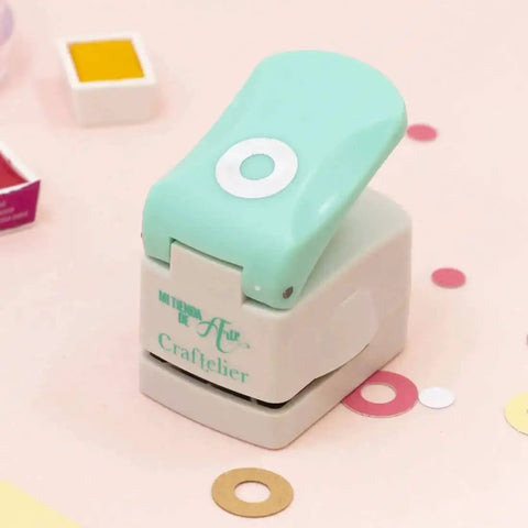 Circle Punch With Reinforcing Ring And Snap Lever for Paper Crafting, Scrapbooking and DIY Card Making, shown with colored grommet examples