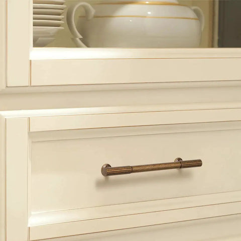 6 Pack Antique Brass Kitchen Cabinet Pulls With 5 Inch Center To Center Spacing installed on a white dresser drawer