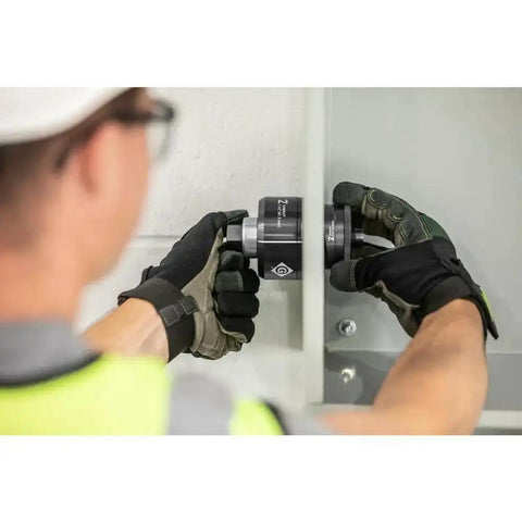 Technician using 1 Inch Conduit Manual Knockout Set K3BB-1 Replaces 73BB With Knurled Grip Punch Laser Markings on panel