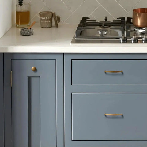 10 Pack Antique Brass Cabinet Pulls With 3 Inch Hole Center on blue kitchen cabinets next to a white counter and gas stove