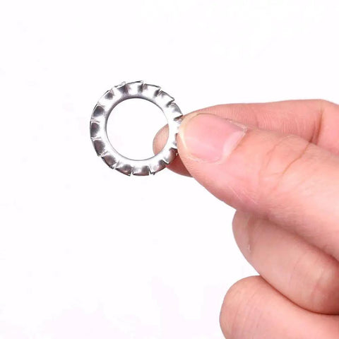Stainless steel external-tooth star washer, close-up view.
