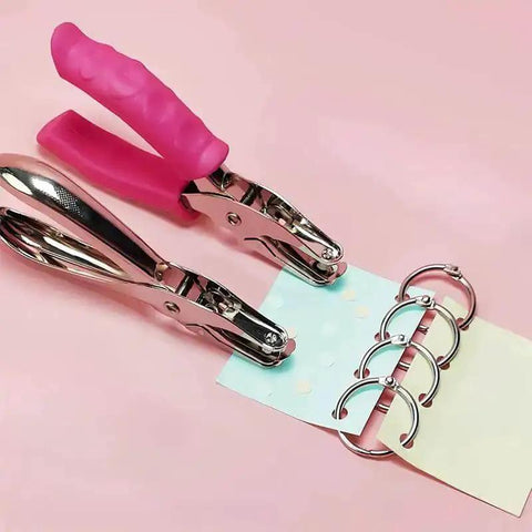 No Fuss Easy Grip One Quarter Inch Hole Punch With Scraps Tray Round Circle Punch showing pink handle and binder rings in use