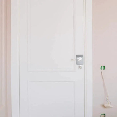 Front view of a door with a 4 Pieces Door Reinforcement Plate Set For Door Handle Fixing Cover Filler Backplate installed.