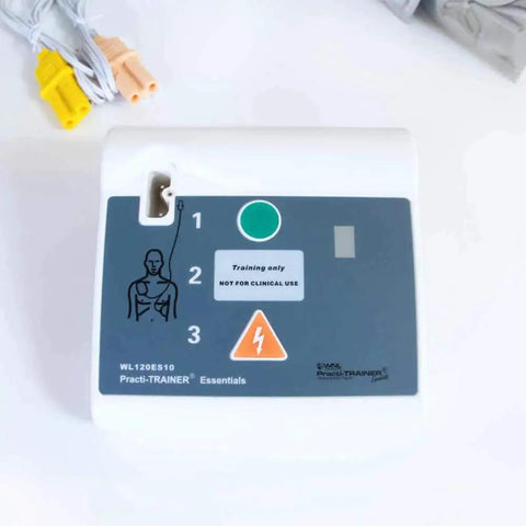 Base model AED Defibrillator Practi Trainer device close-up with training indicators and connectors visible.