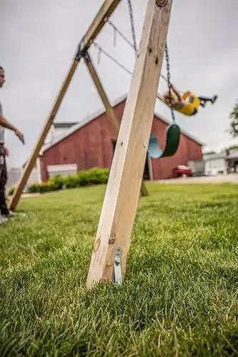 Close-up of installed Playset Anchor Kit For Swing Sets Heavy Duty Ground Anchors on a wooden swing set in a backyard