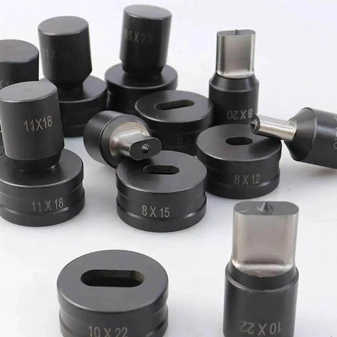 Various sizes of oval punch dies for hydraulic machines, including Oval Hole Punch Die For CH-70 Hydraulic Punching Machine, displayed on a surface.
