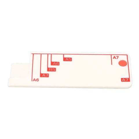 White plastic paper size guide with red markings for A6-A7 dimensions, used with 3 Hole Punch For Scrapbooks And Paper Crafts.