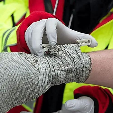 Israeli Style Emergency Bandage 6 Inch Trauma Wound Dressing With Compression being applied by medic on arm in field care.
