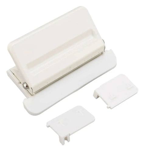 Mushroom Shaped Four Hole Paper Punch With Built In Ruler And Positioning Posts Metal Handheld Punch displayed on a flat surface