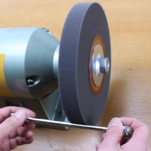 Nylon Fiber Buffing Wheel 8 Inch 9P Hardness With Silicon Carbide Abrasive 180 Grit Five Eighths Inch Arbor in use on grinder