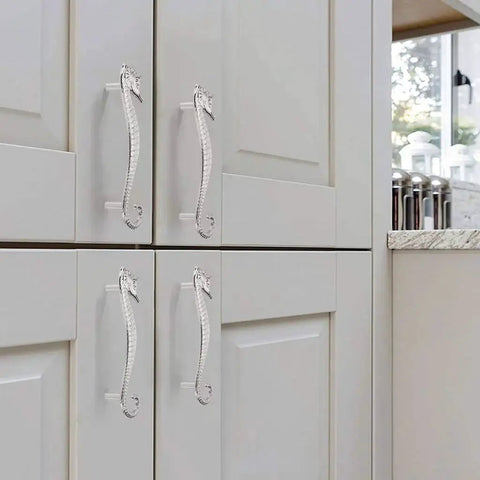 Seahorse Shaped Drawer Pulls Ocean Theme Marine Style Cabinet Hardware Zinc Alloy Coastal Metal Decorative Pulls for Dresser Chest Cabinet Cupboard and Closet in Durable Silver Finish installed on white kitchen cabinet doors.
