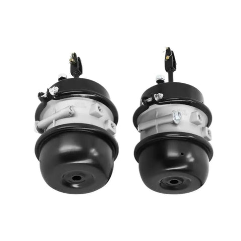 Two air brake chambers, 3 in bore, 30/30 long stroke, black ends with silver mounting flanges.