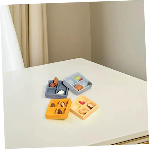 Four Grid Miniature Resin Storage Box Set For Dollhouses And Fairy Gardens with candy and nut ornaments on table