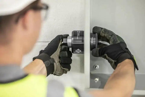 Technician uses Slug Buster Knockout Set For Two Inch Conduit K2BB-2 Replacement For 7211BB-2 with knurled grip in action