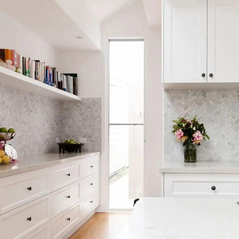 Stylish kitchen with white cabinets featuring black round cabinet knobs set of 50 pieces, 1.2 inch diameter, plastic drawer pulls.
