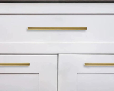 Six Pack 6 Inch Center To Center Brushed Brass Cabinet Pulls installed on white kitchen drawers