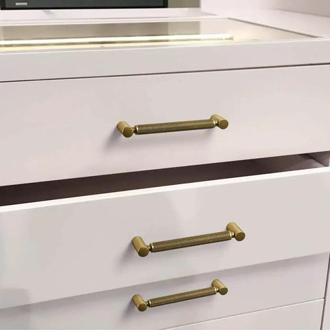 Six Pack 5 Inch Center To Center Antique Brass Cabinet Pulls With Knurled Grip And Circular End Caps on white drawers
