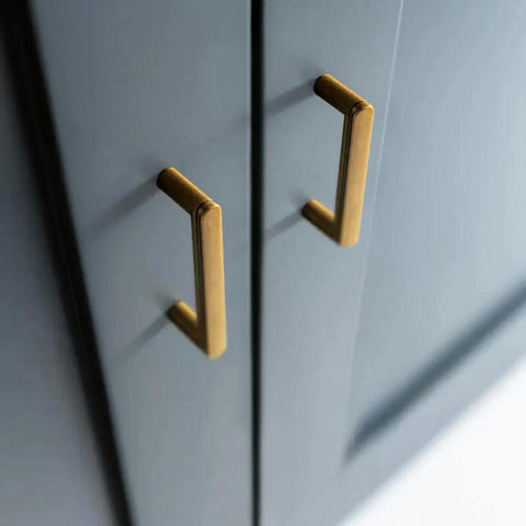 Set Of 6 Cabinet Pulls 3 Inch Center To Center Antique Brass Finish installed on dark cabinetry, showcasing minimalist style.