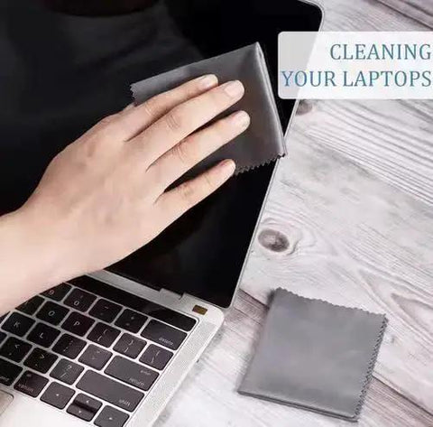 Hand using 10 Pack Microfiber Lens Cleaning Cloths 6x7 LintFree for Glasses Cameras Phones on laptop screen