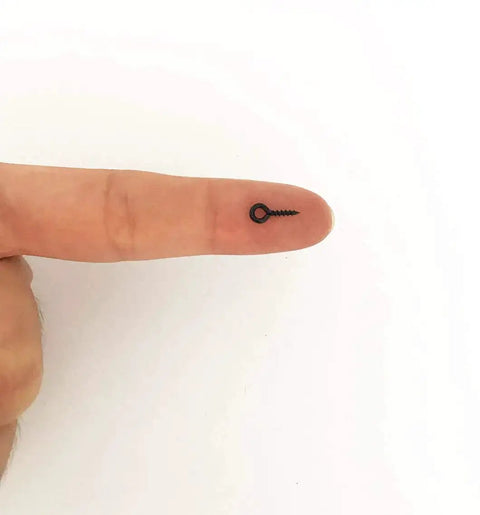 Black Tiny Screw Eye Pins Hooks For Jewelry Making And Craft Projects 250 Pcs Small Eyelets shown on finger for scale