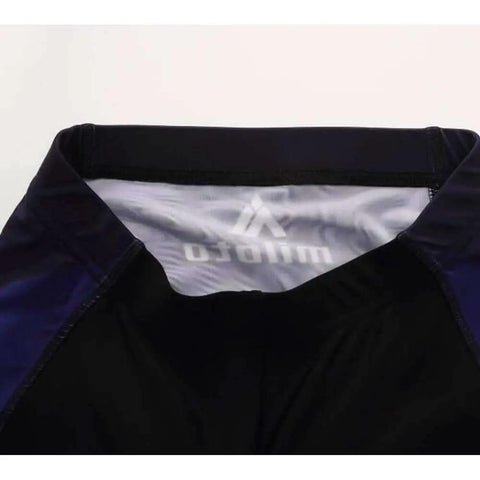 Close-up of waistband with logo on black and blue athletic shorts.
