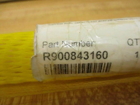 Product label showing part number R900843160 for piston rod with protective yellow mesh packaging visible.