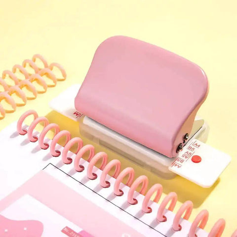 Pink Six Hole Paper Punch For A4 A5 Notebooks with 6mm holes, shown with spiral binders and paper on yellow background.