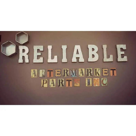 Sign reading 'RELIABLE AFTERMARKET PARTS INC' with decorative hexagons on a brown background.
