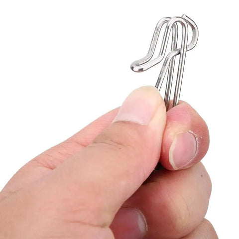 Close-up of a hand holding Board Mast Release Snap Clip Clamp For Downrigger And Outrigger Boat Fishing, marine grade stainless steel