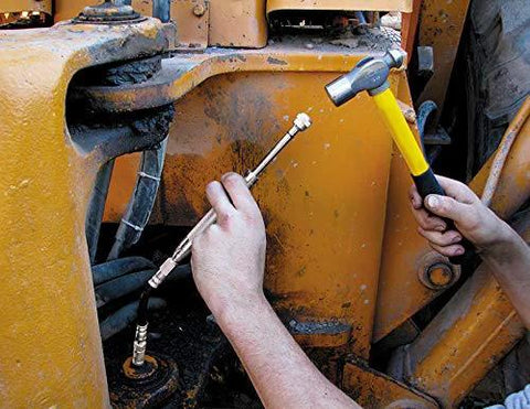 Grease Joint Rejuvenator Kit in use on yellow construction equipment; technician handles metal tool and hammer