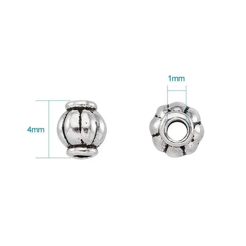 Antique Silver Tibetan Style Pumpkin Spacer Beads 4mm, 100 Piece Set for DIY Jewelry Making, close-up showing 4mm diameter and 1mm hole